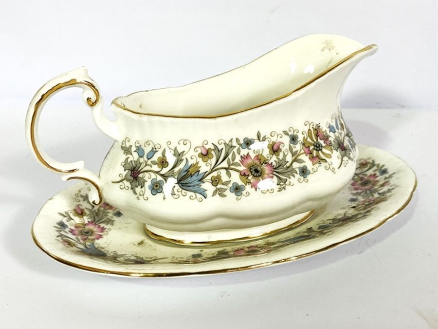 A large assortment of bone china, including a part dinner service, decorated with bands of