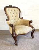 A Victorian button upholstered spoon backed armchair, with scroll moulded back and arms and set on