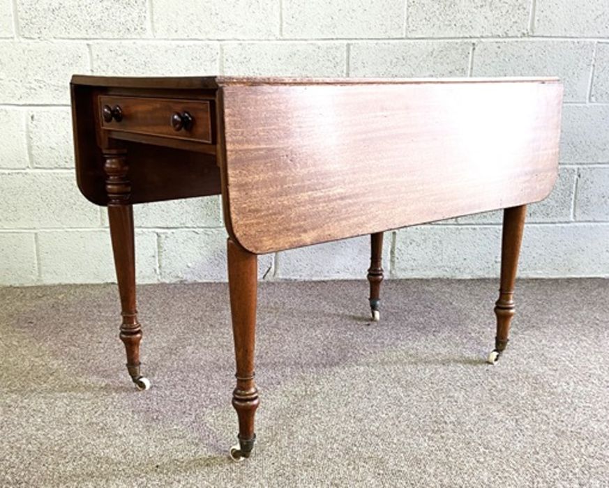 A mahogany Pembroke table, late 19th century, with a rounded drop leaf top, a single end drawer