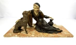 An Art Deco style figure of a reclining Arabian lady and her dog, bronzed and painted resin on a