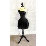A useful dressmakers mannequin, on an ebonized tripod stand, including a Vintage little black dress
