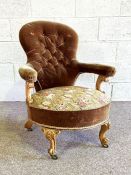 A Victorian walnut framed and button upholstered bedroom armchair, mid 19th century, with scrolled