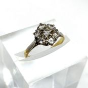 A vintage diamond cluster ring, set in 18 carat gold and platinum, with seven brilliant cut small