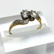 An attractive Diamond double stone ring, with an 18 carat gold setting, set with two approx half