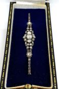 A vintage diamond bar brooch, retailed by Hemmings Ltd, London, with a cluster of old round cut