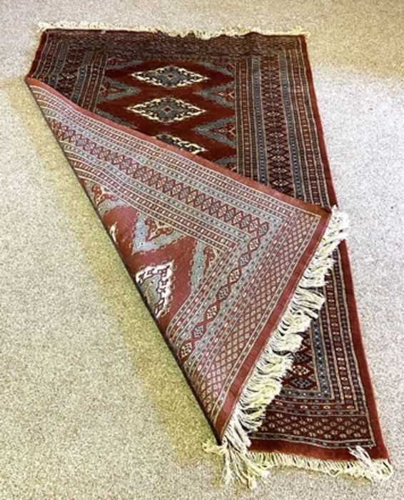 A modern Kazak rug, with six medallions on a dark burgundy ground, modern - Image 3 of 3