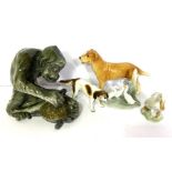 A group of ceramic animal figures, including a large monkey catching a terrapin; a retriever; duck