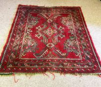 A small Kazak rug, 20th century, with red ground and stylized central medallion