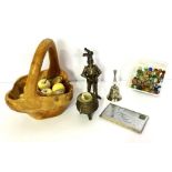 A group of assorted polished agate eggs and fruit, in a rustic carved wood basket, also a table