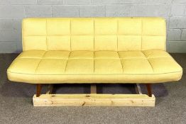 A Dunelm 70’s style ratchet sofa bed, with a folding flat back, upholstered in yellow on deep padded