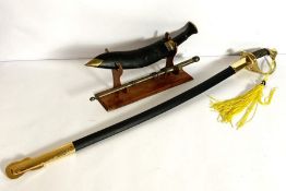 An 1820 type cavalry sabre and scabbard, 20th century, with a modern Kukri and a small decorative