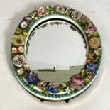 A 19th century Meissen style Duetsche Blumen encrusted table mirror, oval with profuse and varied