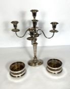 A pair of Sheffield Plate wine coasters, with pierced high sides and wood bases; also a four arm,