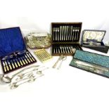 An assortment of silver plated and other flatware, including cased fruit servers with bone
