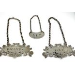 A pair of Victorian silver spirit labels, hallmarked Birmingham 1852, by Nathaniel Mills, with
