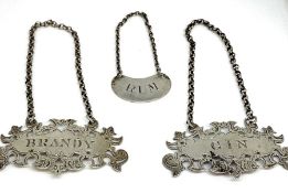 A pair of Victorian silver spirit labels, hallmarked Birmingham 1852, by Nathaniel Mills, with