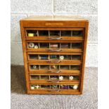 A handy vintage cotton reel store, with multiple small glass fronted drawers