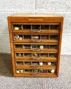 A handy vintage cotton reel store, with multiple small glass fronted drawers