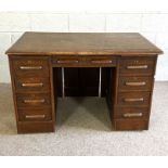 A vintage oak pedestal desk, mid 20th century, with oblong top over arrangement of drawers