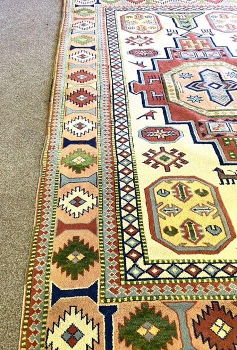 A modern Kazak style decorative rug, decorated with a central medallion on a cream field, 317cm x - Image 4 of 4