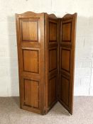 A vintage oak panelled three fold screen, each fold with an arched top, 172cm high, 150cm wide
