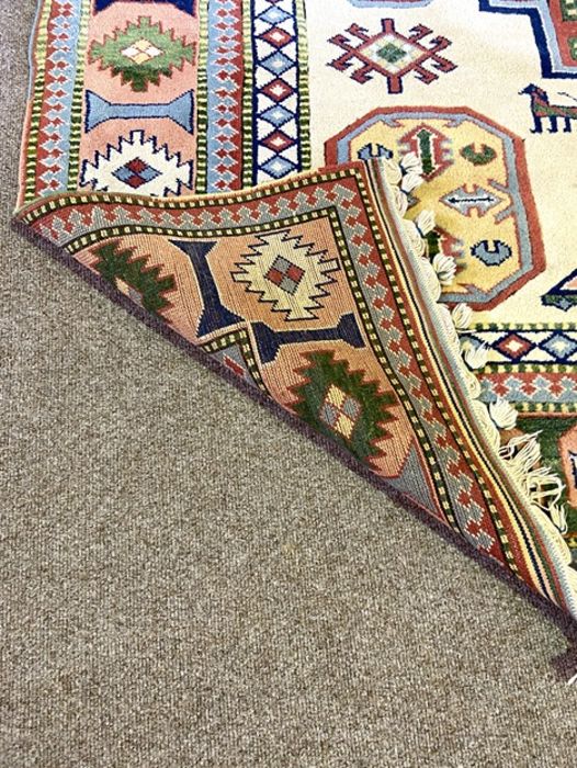 A modern Kazak style decorative rug, decorated with a central medallion on a cream field, 317cm x - Image 3 of 4
