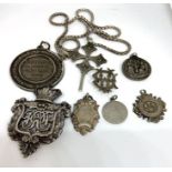 A group of silver pendants and medals, including a Victorian silver Ducal pendant, with initials DC,