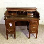 A late Victorian tambour desk, circa 1900, with a tambour front opening to fitted interior, over