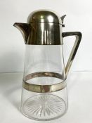 A vintage silver plated and conical glass claret jug, with hinged and domed lid, side handle and