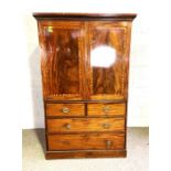 A late Regency mahogany linen press, with moulded cornice, over two flame mahogany veneered panelled