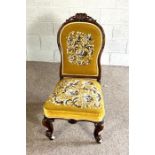 A pretty Victorian walnut framed nursing chair, circa 1870, with later floral tapestry back and