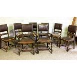 A set of eight Jacobean style oak dining chairs, early 20th century, with padded and scroll carved