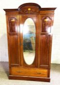 An Edwardian mahogany mirror door wardrobe, with decorative inlays; together with another similar (