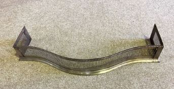 A 19th century fretwork steel fire curb, of serpentine form, with an ogee moulded base