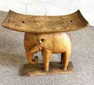 Two carved tribal stools, including one with an elephant support, 20th century (2)