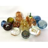 An assortment of colourful glass paperweights, including two hollow pears, millefiori examples and