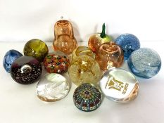 An assortment of colourful glass paperweights, including two hollow pears, millefiori examples and