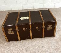 A vintage leather and wood bound travelling trunk, early 20th century, 110cm long; together with
