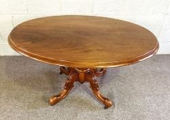 A Victorian mahogany oval hall or library table, circa 1870, with a moulded top, set on a ring