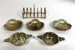 A silver seven bar toast rack, hallmarked, Birmingham 1932, 11cm wide, 61g; together with a set of