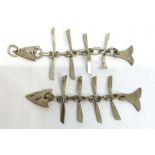 Two novelty flat articulated white metal fish pendants, 800 marked (2)