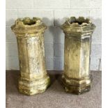A pair of vintage composition stone octagonal chimney pots, with crenellated tops and stepped bases,