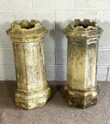 A pair of vintage composition stone octagonal chimney pots, with crenellated tops and stepped bases,