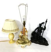 A cast doorstop of a Highlander, 39cm high; also a decorative table lamp with Putti and another lamp