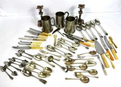 A large assortment of silver plate and mixed flatware, including cake slice, serving forks and