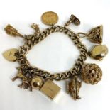 A heavy and attractive 9 carat gold charm bracelet, with an assortment of pendants, including The