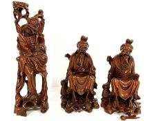 Three Japanese wood Okimono figures, Meiji style, 20th century, including a pair of seated Samurai