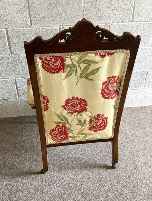 A late Victorian easy chair, with carved back and padded armrests, currently upholstered in floral - Image 6 of 6