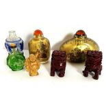 A group of small Chinese and Japanese decorative snuff bottles, together with a pair of resin