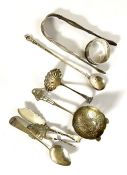 A group of small silver including pair of of sugar tongs, a casting spoon, and a napkin ring etc. (a